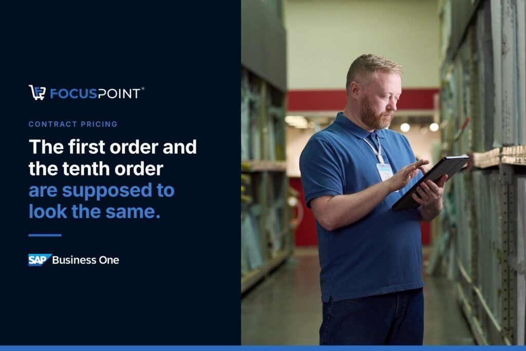 Employee checking pricing on a tablet in a distribution center.