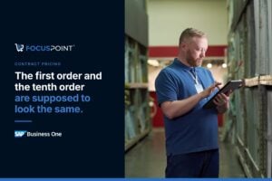 Employee checking pricing on a tablet in a distribution center.